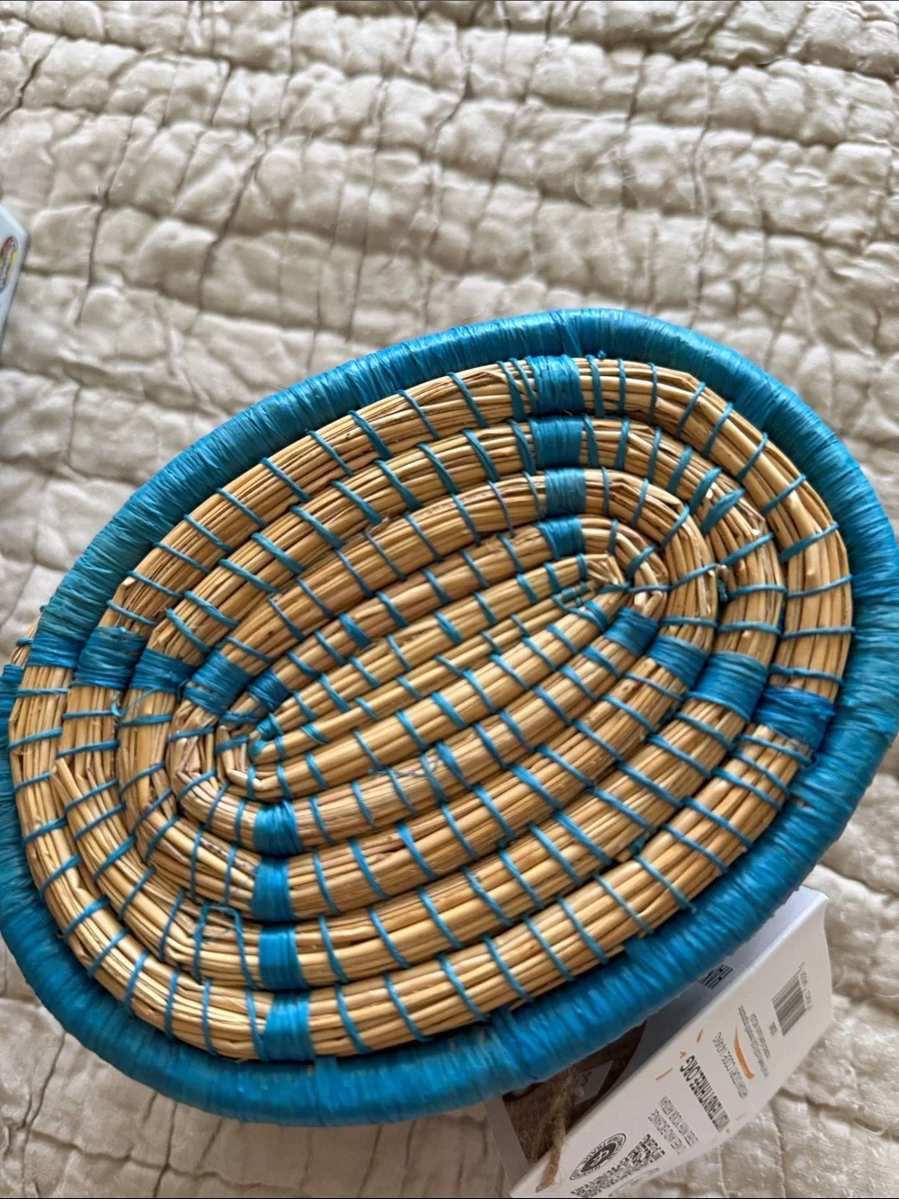 Handmade turquoise and tan coveted basket from Uganda clasp in the front